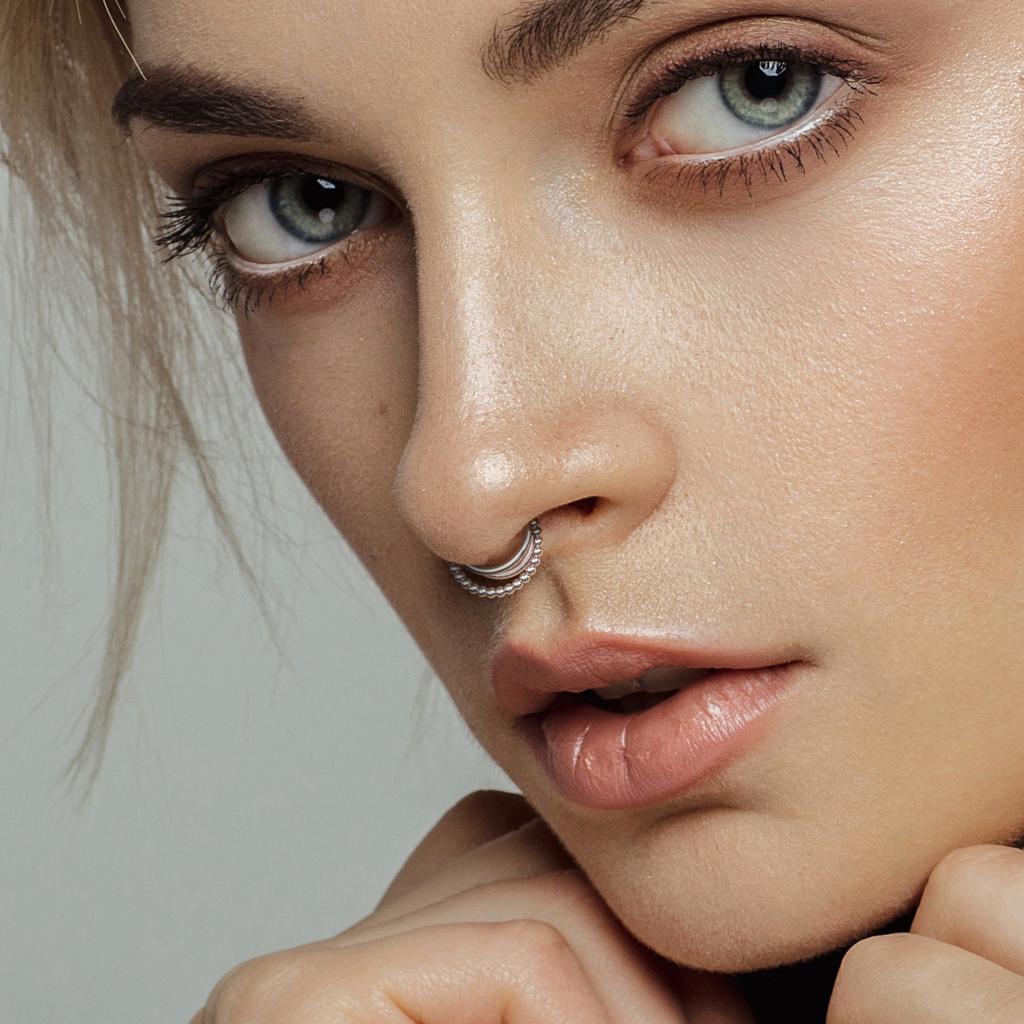 Silver hoop in a septum piercing