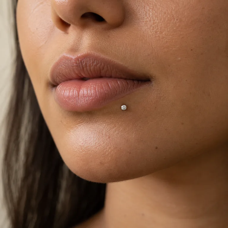 Clear gem labret stud below the lower lip